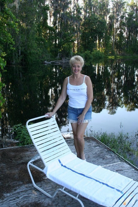 Sexy mature Tracy Lick unveils her great body in the yard to pet her pussy