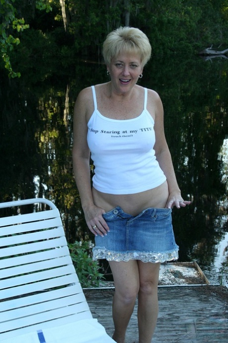 Sexy mature Tracy Lick unveils her great body in the yard to pet her pussy