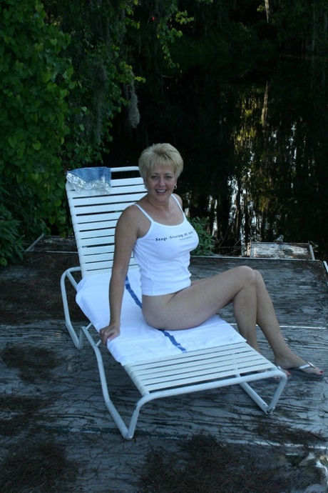 Sexy mature Tracy Lick unveils her great body in the yard to pet her pussy