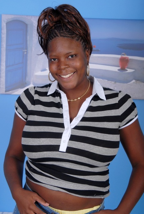 Older black woman Athena holds her large breasts while getting undressed