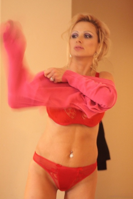 Older blonde Sharon Pink sets her fake tits loose while getting changed