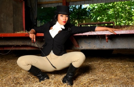 Hot MILF Danica Collins works free of riding apparel at a farm