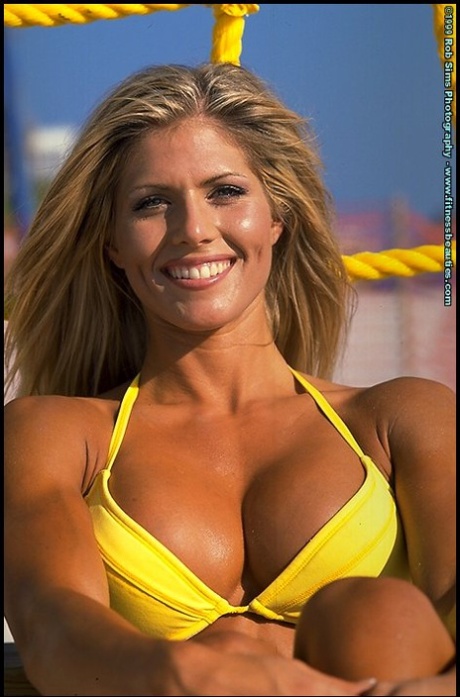 Blonde fitness model Torrie Wilson poses in bikinis while at the beach
