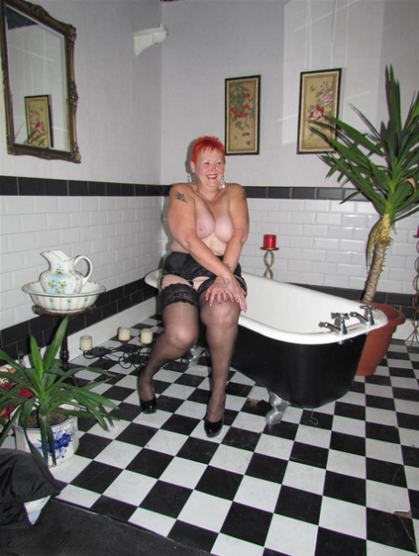 Thick redhead Valgasmic Exposed changes garter belts while naked in stockings