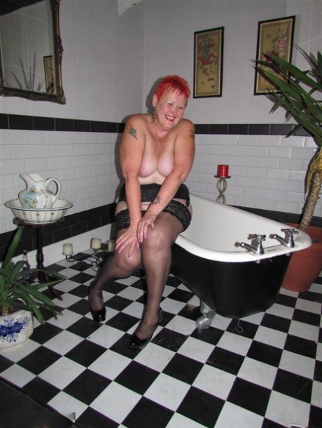 Thick redhead Valgasmic Exposed changes garter belts while naked in stockings