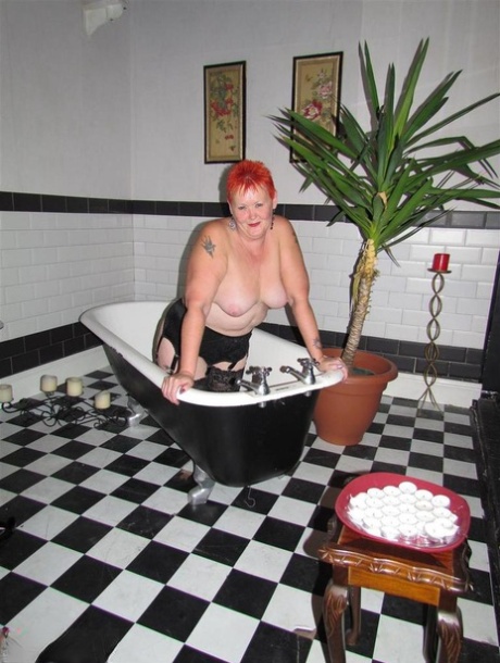 Thick redhead Valgasmic Exposed changes garter belts while naked in stockings