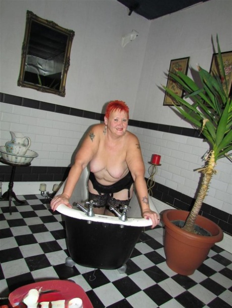 Thick redhead Valgasmic Exposed changes garter belts while naked in stockings