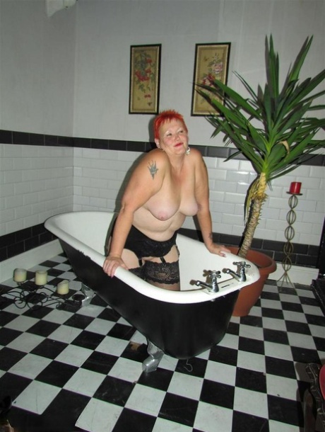 Thick redhead Valgasmic Exposed changes garter belts while naked in stockings