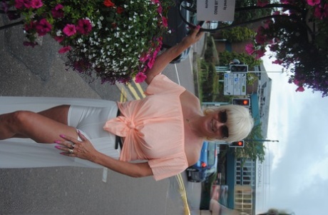 Mature British woman Denise Davies likes flashing her saggy tits in public
