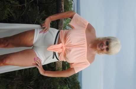 Mature British woman Denise Davies likes flashing her saggy tits in public