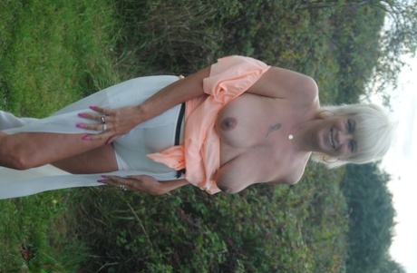 Mature British woman Denise Davies likes flashing her saggy tits in public