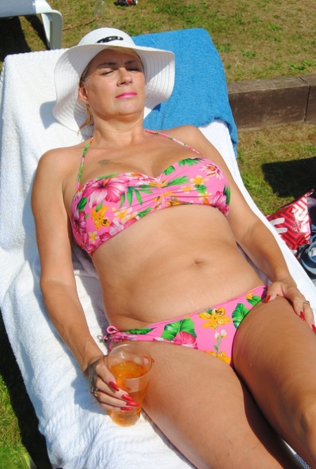 Mature British woman Denise Davies likes flashing her saggy tits in public