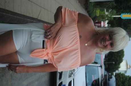 Mature British woman Denise Davies likes flashing her saggy tits in public