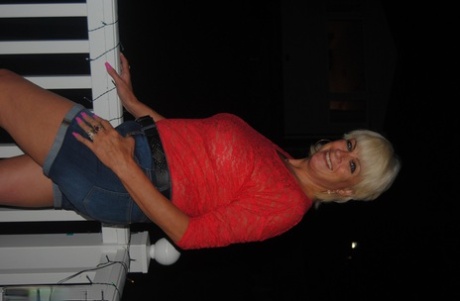 Mature British woman Denise Davies likes flashing her saggy tits in public