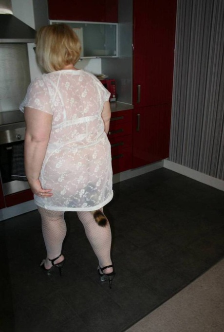 Fat UK woman Lexie Cummings shows her pierced cunt while sporting a butt plug