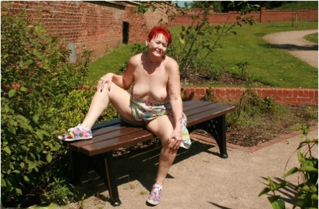 Older redhead Valgasmic Exposed gets totally naked in a public park