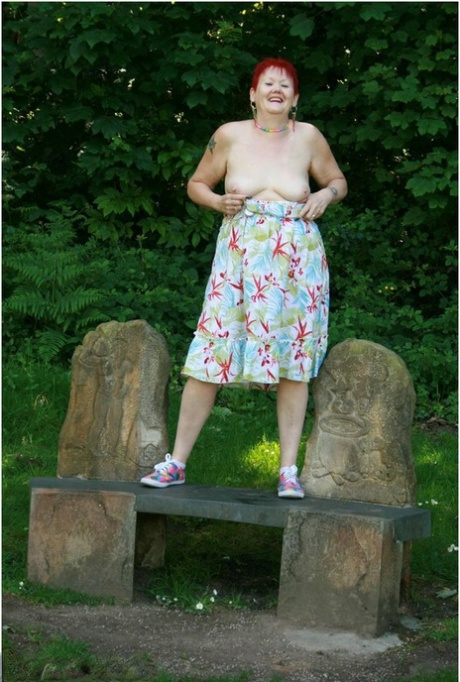 Older redhead Valgasmic Exposed gets totally naked in a public park