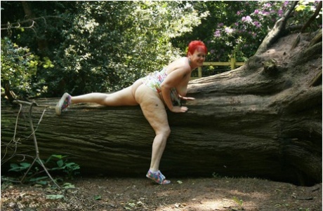 Older redhead Valgasmic Exposed gets totally naked in a public park