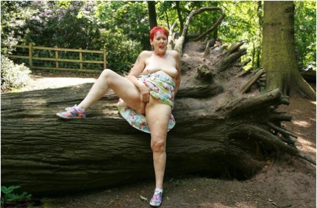 Older redhead Valgasmic Exposed gets totally naked in a public park