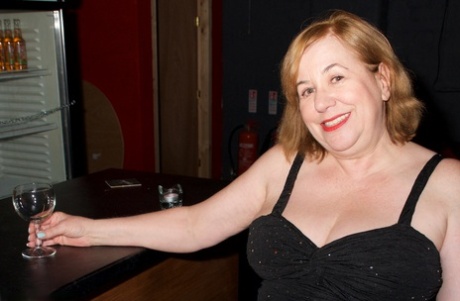 Mature fatty Speedy Bee uncovers her large tits before masturbating in a bar