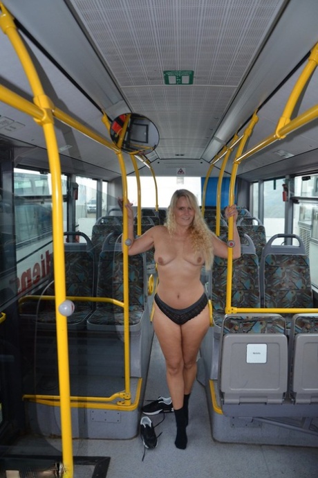 Thick blond chick takes off her underwear to pose naked in socks on a city bus