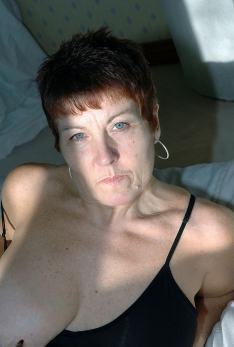 Mature redhead Savana wears her hair short during a hardcore POV fuck on a bed