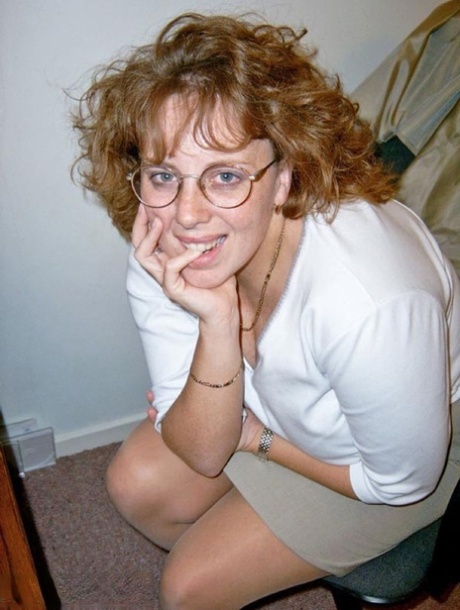 Mature redhead Curvyclaire dons thigh high boots after stripping to lingerie