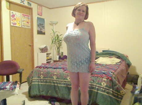 Fat mature mom Misha bares saggy boobs to fist her hot pussy on the bed