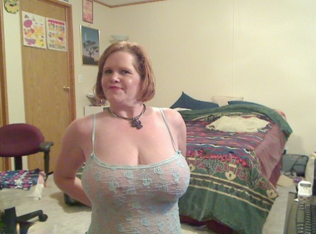 Fat mature mom Misha bares saggy boobs to fist her hot pussy on the bed