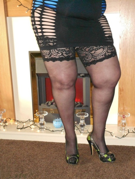 Flamboyant redhead SSBBW bares huge big tits to model sexy lingerie in heels