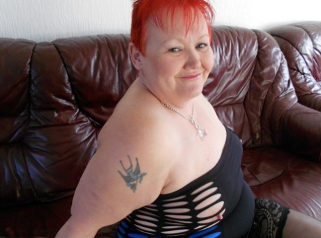 Flamboyant redhead SSBBW bares huge big tits to model sexy lingerie in heels
