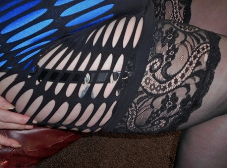 Flamboyant redhead SSBBW bares huge big tits to model sexy lingerie in heels
