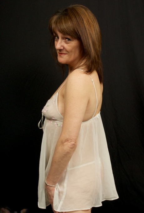 Horny older Pandora sheds sheer white lingerie to spread her mature ass