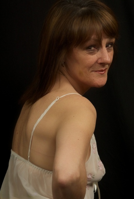 Horny older Pandora sheds sheer white lingerie to spread her mature ass