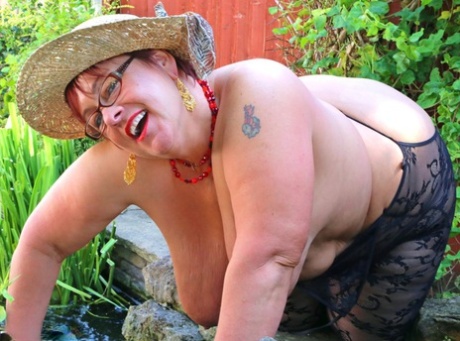 Older fatty unleashes her huge boobs in crotchless bodystocking and sun hat