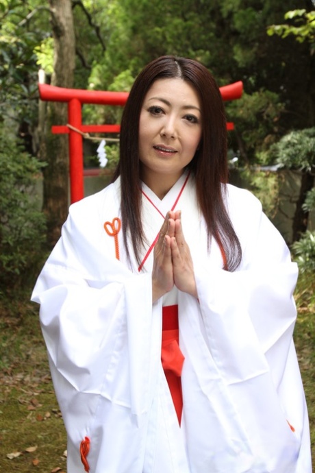 Older Japanese woman Ayano Murasaki exposes her tits and bush out in the yard