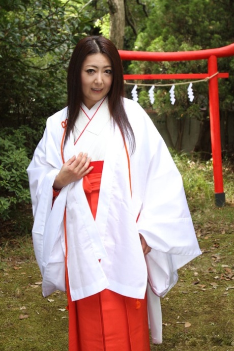 Older Japanese woman Ayano Murasaki exposes her tits and bush out in the yard