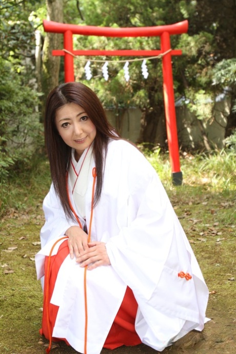 Older Japanese woman Ayano Murasaki exposes her tits and bush out in the yard