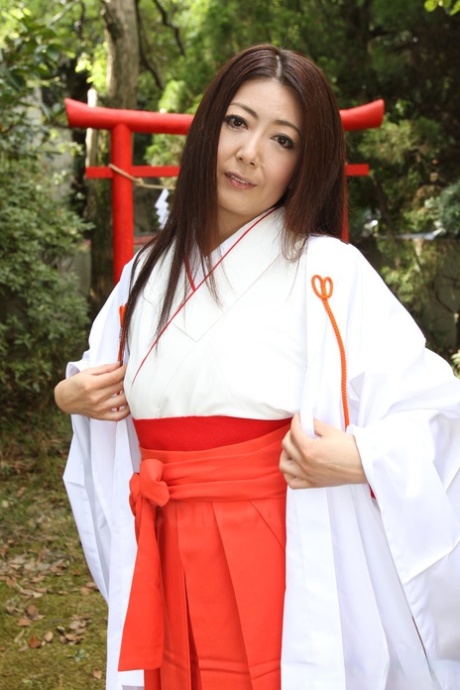 Older Japanese woman Ayano Murasaki exposes her tits and bush out in the yard