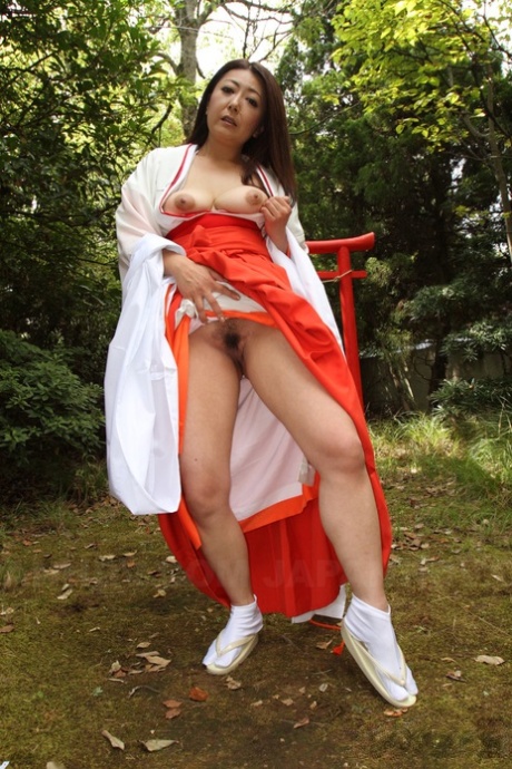 Older Japanese woman Ayano Murasaki exposes her tits and bush out in the yard