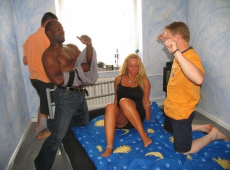 Blonde amateur gets gangbanged on her bed by black and white men
