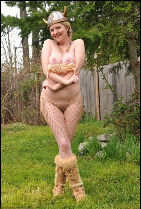 Mature blonde Tasty Trixie shows off her great tits outside in Viking attire