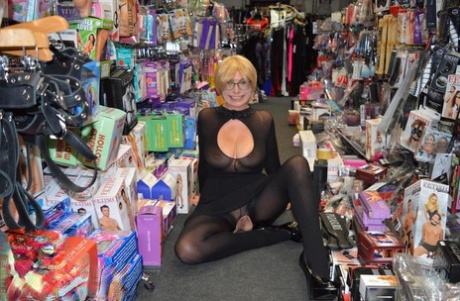 Mature woman flashes her tits and twat on sidewalk and in sex shop