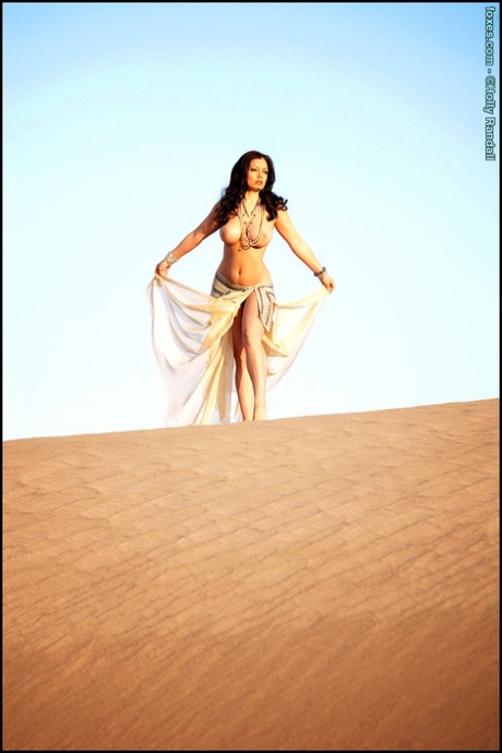 Gorgeous brunette Aria Giovanni shows her nice tits and snatch on a sand dune