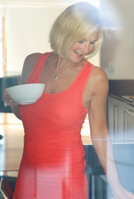 Mature blonde Molly MILF sets her large boobs free of red dress in solo action