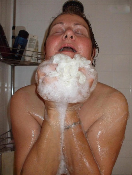 Naked older woman Busty Bliss washes her big boobs while taking a shower