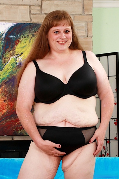 Old fatty Trixxx Foster sports long red hair while fingering her naked pussy