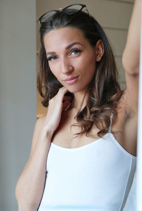 Teen solo girl Kenya slips off a white bodysuit before showcasing her vagina
