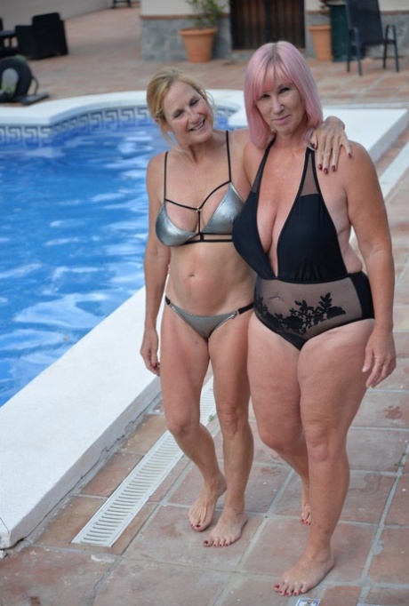 Middle-aged lesbian Melody and her girlfriend kiss while in an outdoor hot tub