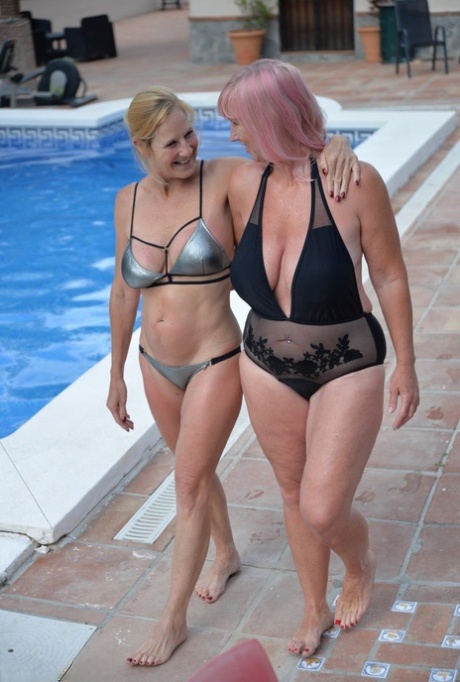 Middle-aged lesbian Melody and her girlfriend kiss while in an outdoor hot tub